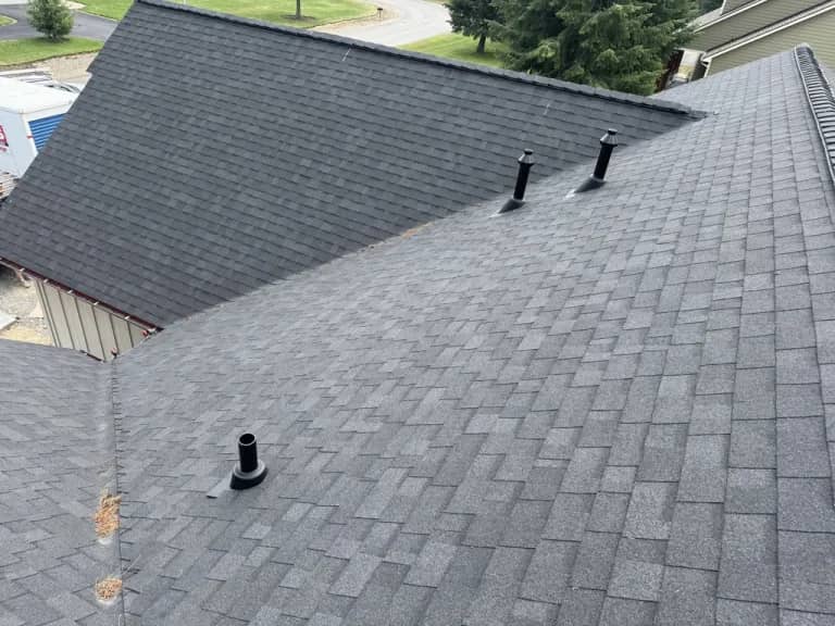 Dover asphalt shingle roof overview Elevated view of dark asphalt shingles, roof vents, and adjoining roof planes on a home in Dover, Idaho