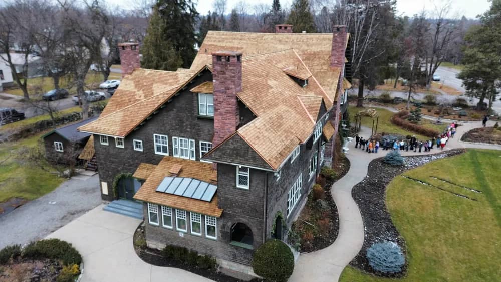 Cedar shingle roof front aerial view Front aerial view of a cedar shingle roof on a large shingle-style home