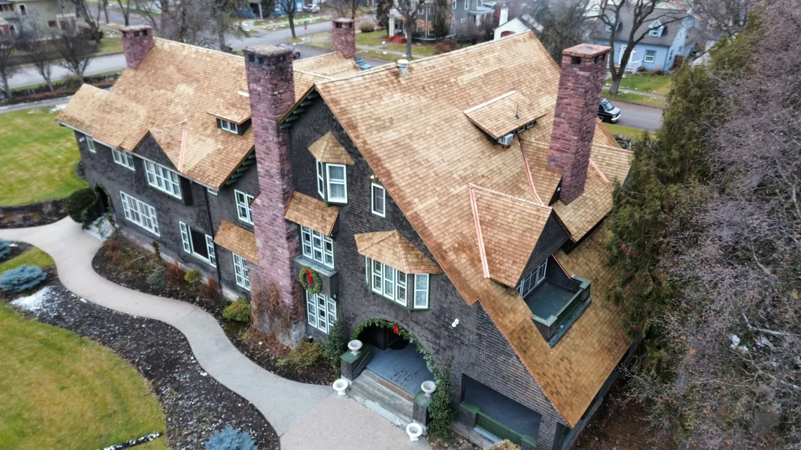 Cedar shingle roof and brick chimneys viewed from above